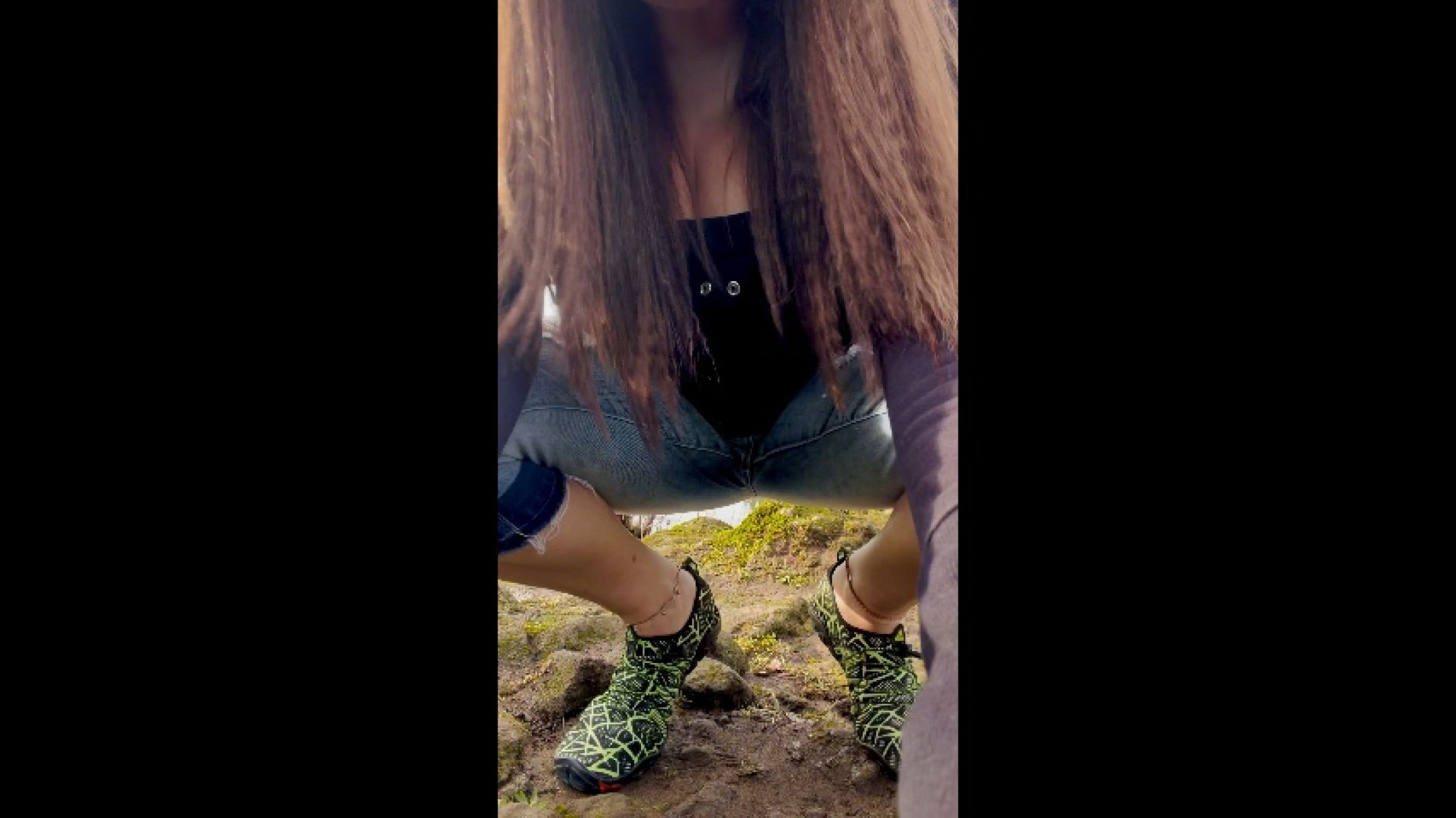 Putting on water shoes by riverfront